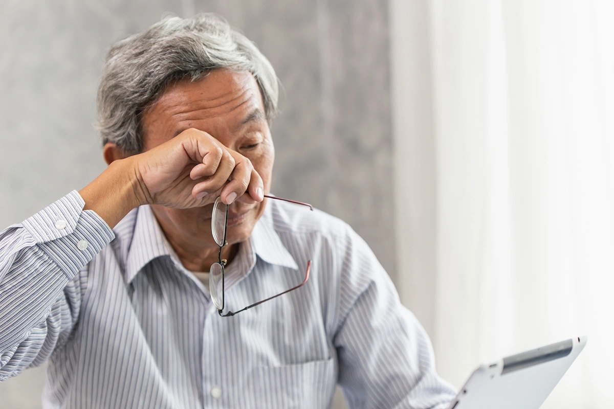 Man experiencing blurred vision while struggling to focus on everyday activities. 